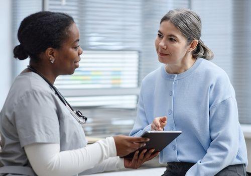 Doctor talking with a woman patient during a 45 to 49 years preventive health check