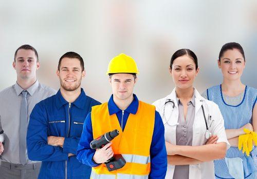 Group of workers from different trades standing with a healthcare worker before pre employment medicals