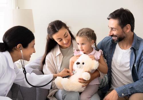 GP checking a young child with her parents during a family medicine appointment at Harbour Town Doctors