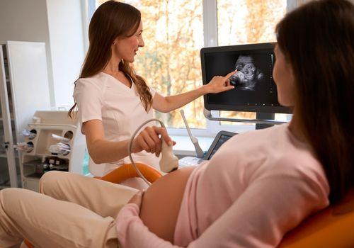 Pregnant woman having an ultrasound scan during an antenatal appointment