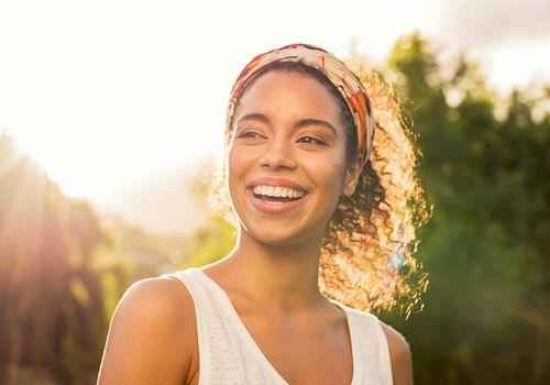 Woman smiling outdoors before a women's health check appointment
