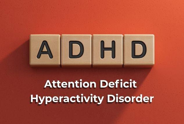 Wooden letter tiles spelling ADHD above the words Attention Deficit Hyperactivity Disorder