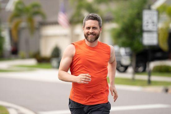 Man jogging outdoors on the Gold Coast, staying active between men's health checks at Harbour Town Doctors